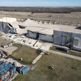 Collapsed commercial roof caused by snow and ice load – large loss building failure requiring structural stabilization