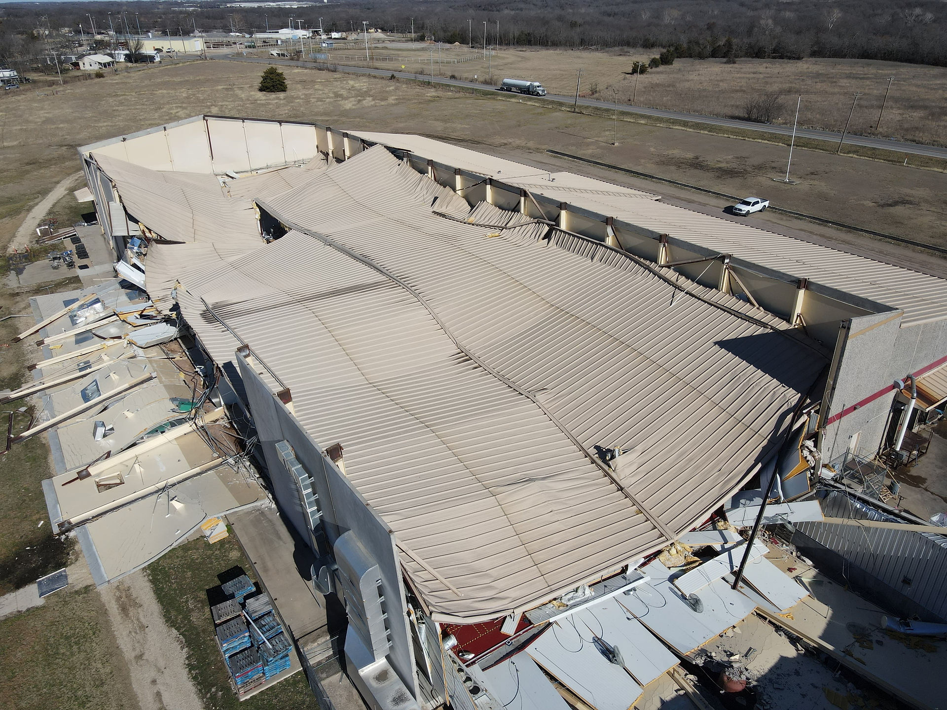 Collapsed commercial roof caused by snow and ice load – large loss building failure requiring structural stabilization