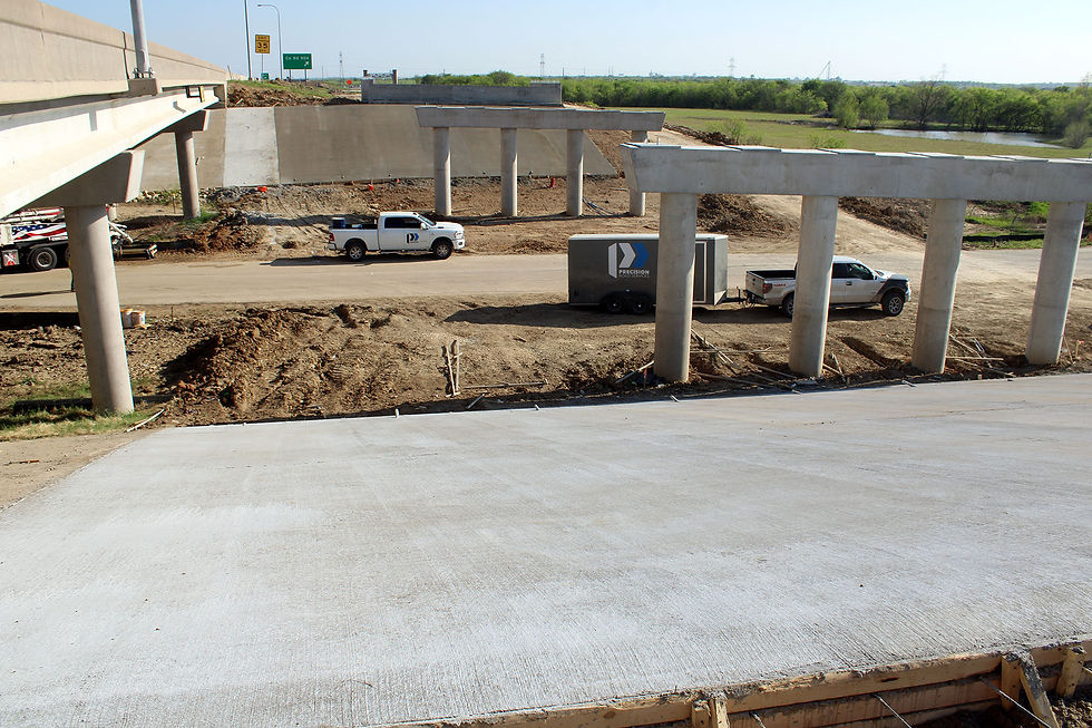Construction work on Chisholm Trail Parkway with rip rap installation and roadway expansion by Precision Road Services in Fort Worth Texas
