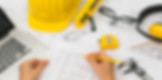 Architect reviewing field measurements via blueprints and tools