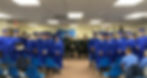 Tumi graduation with inmates wearing blue gaps and gowns