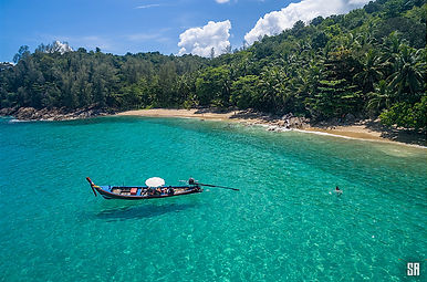 Aerial view of a long-tail boat anchored off the beach in Banana Bay