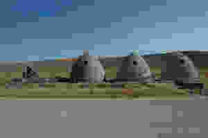 Three beehive-shaped charcoal kilns on the Wyoming plains. Piedmont charcoal kilns in Wyoming.