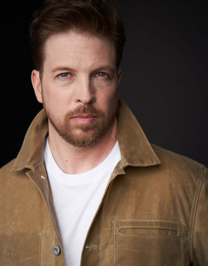 Michael Lieberman wearing a tan wax jacket and a white t-shirt