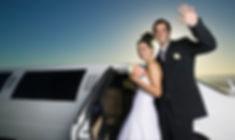 Happy couple near limousine at night ready for honeymoon