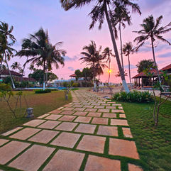 Tropical garden pathway at ETHER Marari Beachfront, boutique beach resort in Marari, Kerala