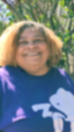 Jacinta Wills, LPC smiling wearing a pruple 3d Psychotherapy shirt