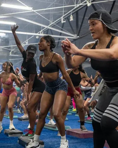 Group of women doing step aerobics in a gym