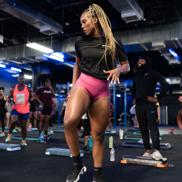 Athletic woman doing step-ups in a gym