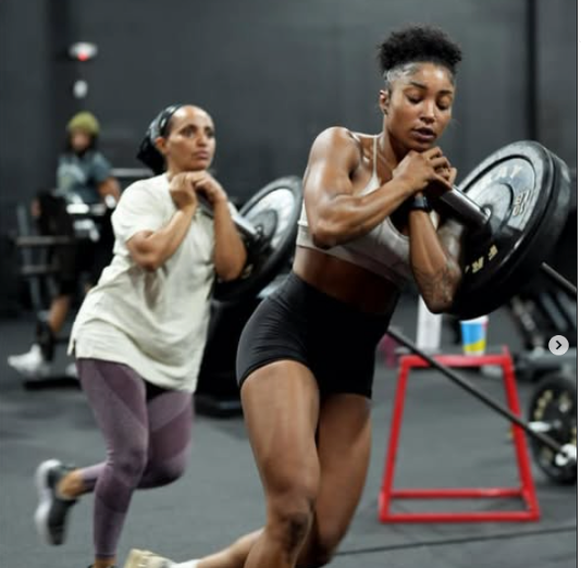 Two women doing strength training in a gym