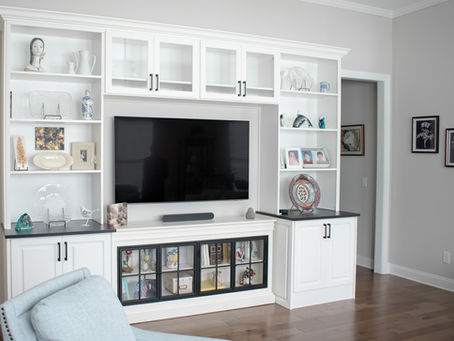 Custom home entertainment center in Orlando with modern shelving and lighting for movie nights