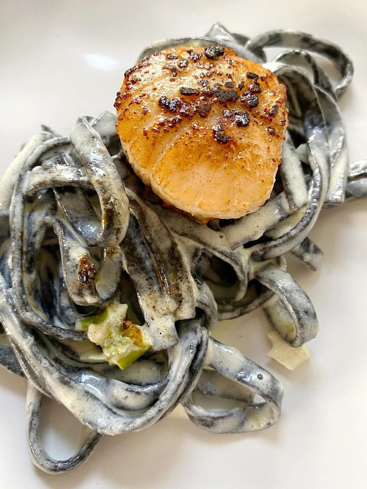 Squid ink pasta with seared scallops in a truffle alfredo