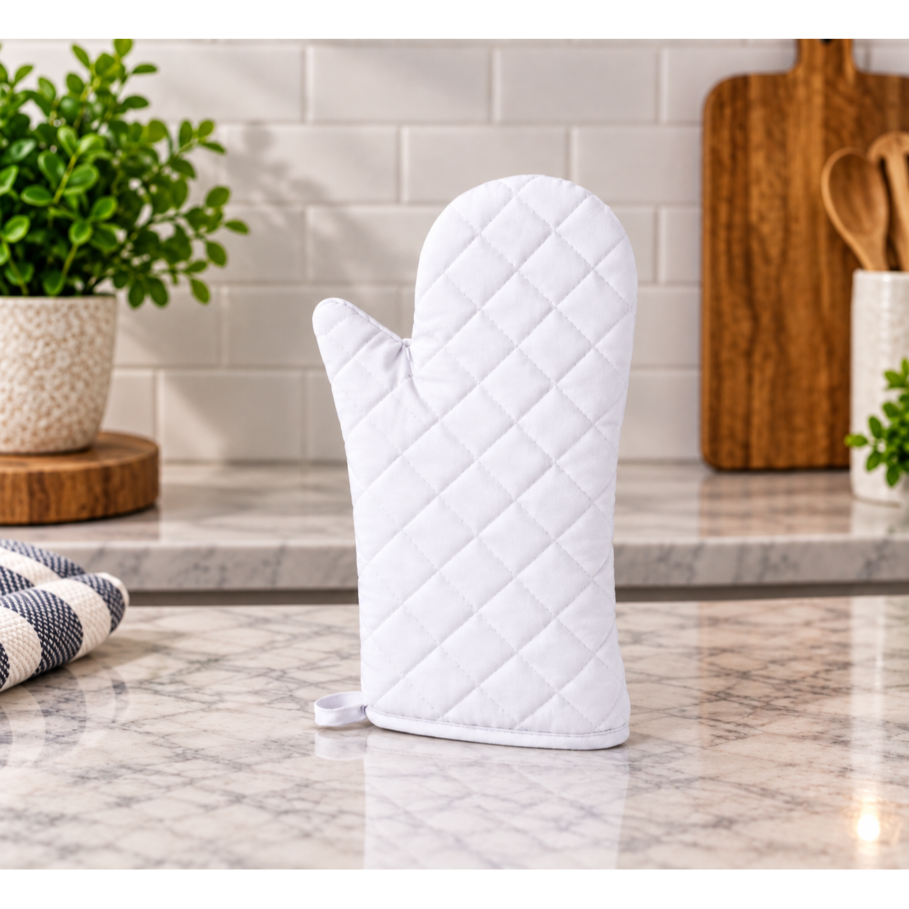 Quilted white oven mitt on a kitchen counter