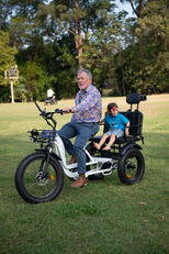 Riding a tricycle at First2Cares annual Picnic in the Park