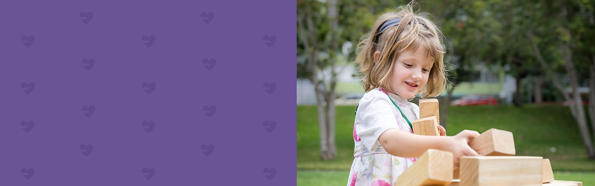 First2Care Picnic in the park, little girl playing with blocks.