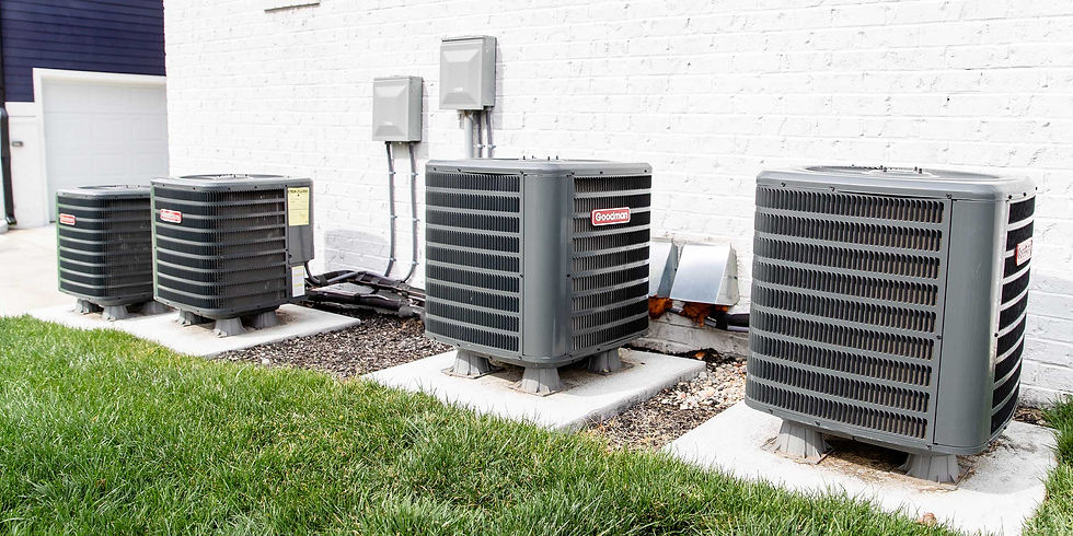 multiple HVAC units next to each other on a lawn