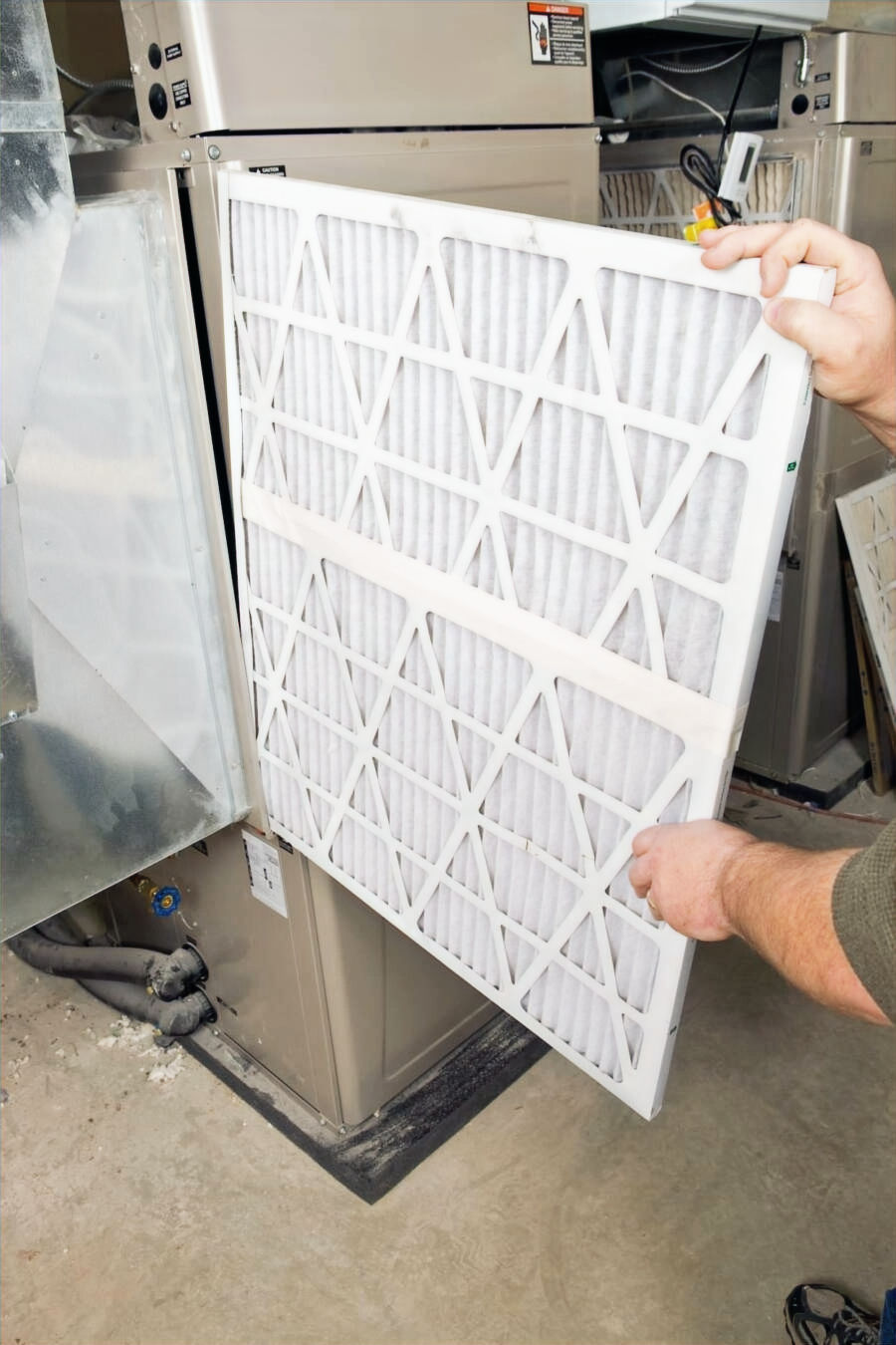 air filter being placed into a vent inside a home