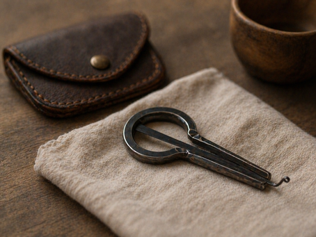 Jaw Harp On The Table on top of a cloth beside a case
