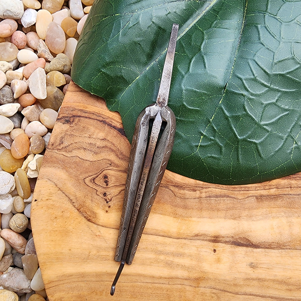 Small Iron Afghani Jaw Harp on a wooden plate