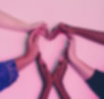 several hands making a heart