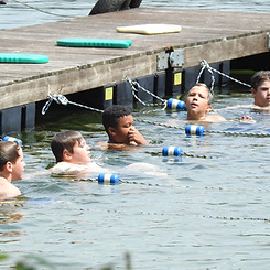 Boys in the lake at a swim lesson.