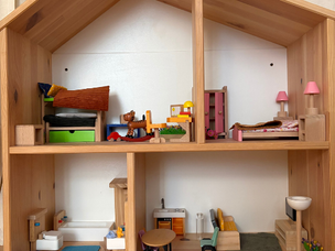 A dollhouse decorated with toy furniture.