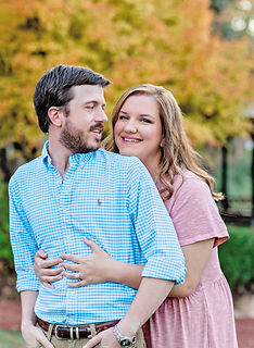 Couple poses in fall foliage during Montgomery, AL Couples session