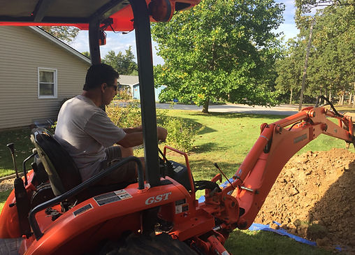 Owner operating orange backhoe