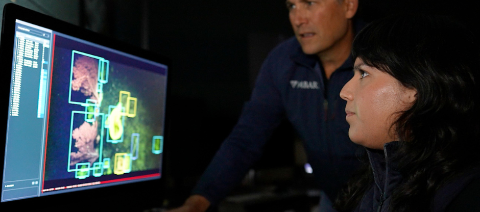 Two people looking at a computer screen