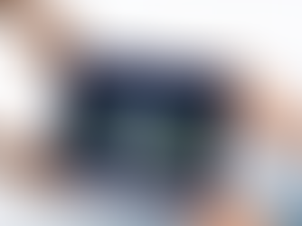 Hands hold a tablet displaying a marine image with "fathomverse" text. The net-like background suggests an oceanic theme.