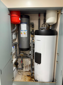 Hot water cylinder and buffer vessel in cupboard