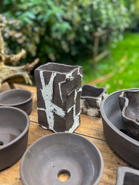 Japanese style handmade black clay pottery pieces showcased on a table