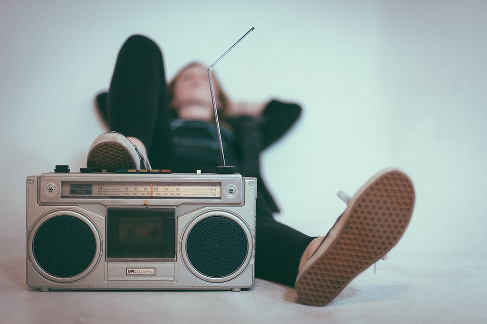 Person relaxing with a retro radio