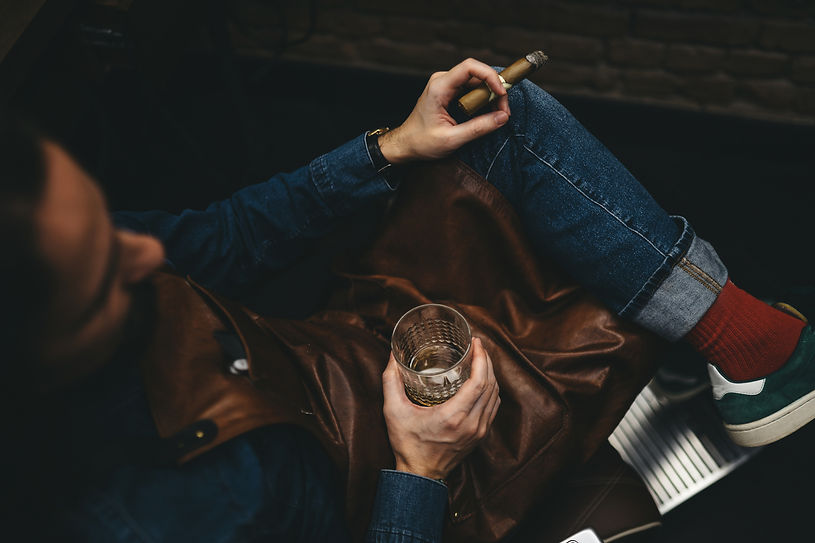 man drinking whiskey and smoking cigar.jpg
