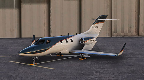 Cascade Executive Aviation FlightFx HondaJet Elite II N420CX parked in front of a hanger at golden hour painted in alpine white, with a dark blue tail, with copper and silver highlights