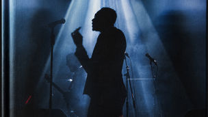 October London in silhouette under a blue spotlight.