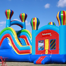 hot air balloon bouncer bold red blue and yellow colour, inflated with blue sky in background