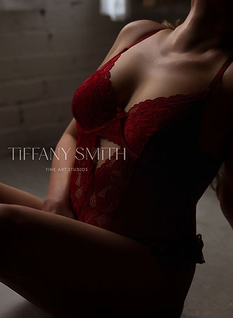 WOMAN SITTING ON FLOOR IN RED PITTSBURGH BOUDOIR STUDIO