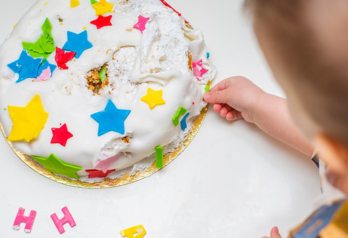 child-decorates-colorful-birthday-cake-with-letter-2026-09-22-09-52-23-utc.jpg