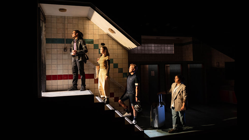Four travelers stand on tiled station stairs under dramatic light, one with a suitcase, in a moody underground scene