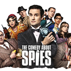 Group of eight people in vintage attire, some with suspicious expressions. Central text reads "The Comedy About Spies."
