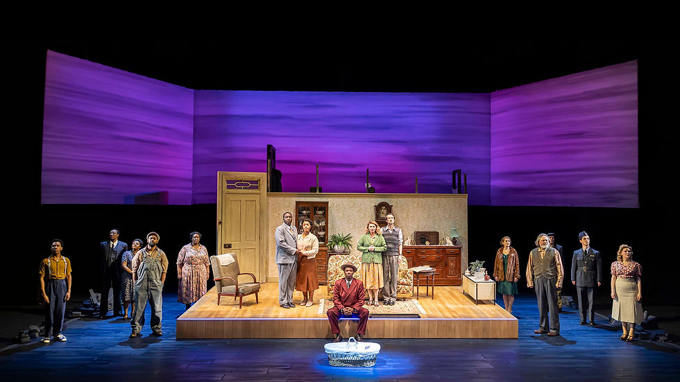 Stage with diverse actors in 1940s attire; wooden set with chairs, couch, and decor. Purple-lit background suggests dramatic mood.