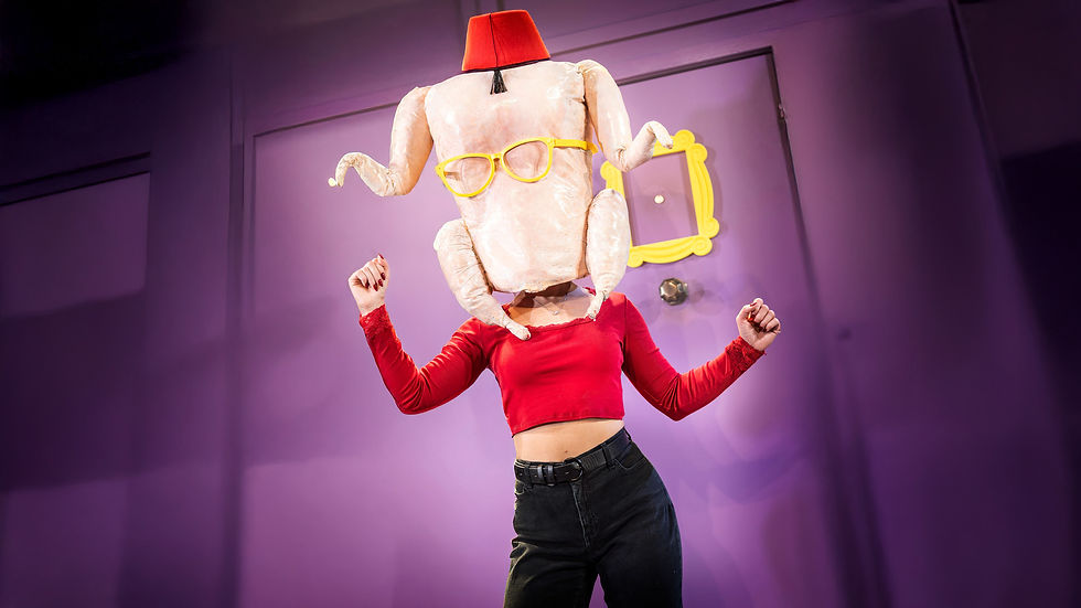 Person in a red top wears a funny turkey hat with glasses, raising fists playfully. Purple wall background with a yellow frame accent.