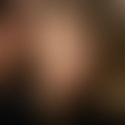 Double Indemnity Play Artwork. A woman with blonde hair and red lipstick looks forward with a serious expression. A man is whispering in her ear. Blurred dark background.