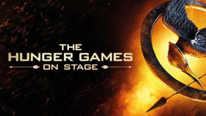 The Hunger Games: On Stage Poster. A Mockingjay pin with an arrow on a fiery background. Text reads: "The Hunger Games On Stage" in bold letters.