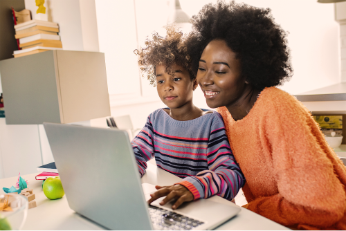 Parent helping child manage ADHD symptoms with schoolwork support