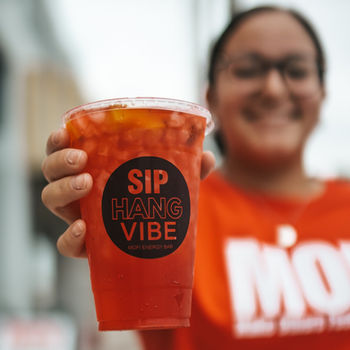 Red hydration tea drink with Sip Hang Vibe branding – MOFI Energy Bar