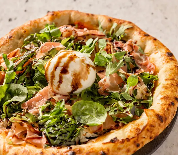 Gourmet artisan pizza served at Hotel Mousai Cancun restaurant