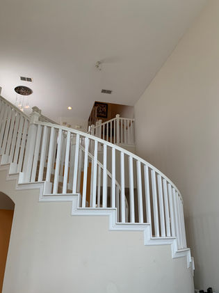Custom curved staircase with white painted wood railing — South Padre Island TX