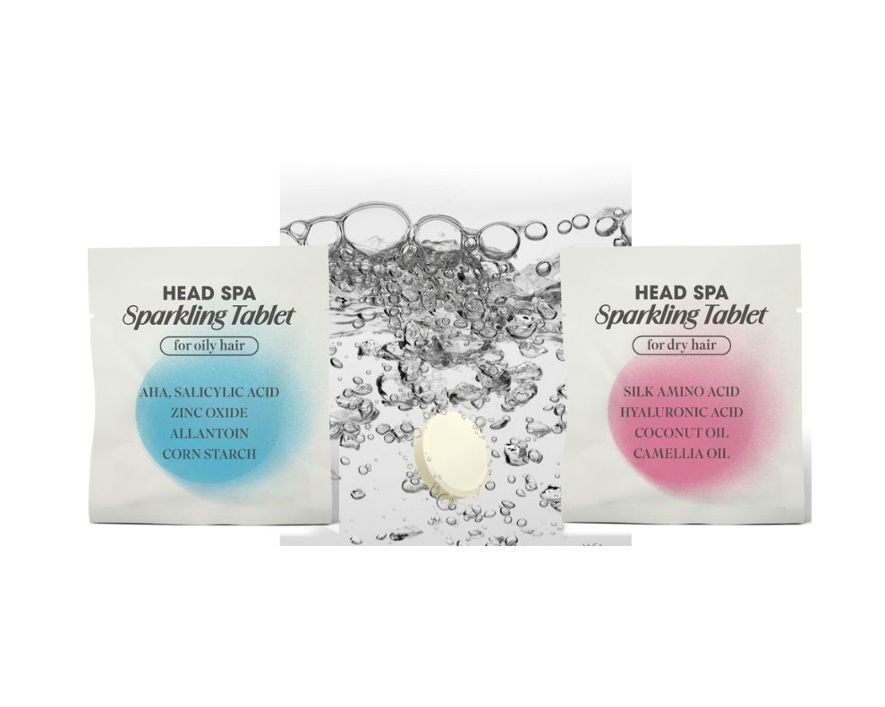 blue and pink tablet packets with sparkling tablet in water with bubbles surrounding it